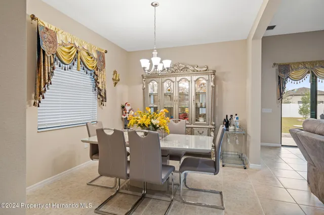 a view of a dining room with furniture and chandelier