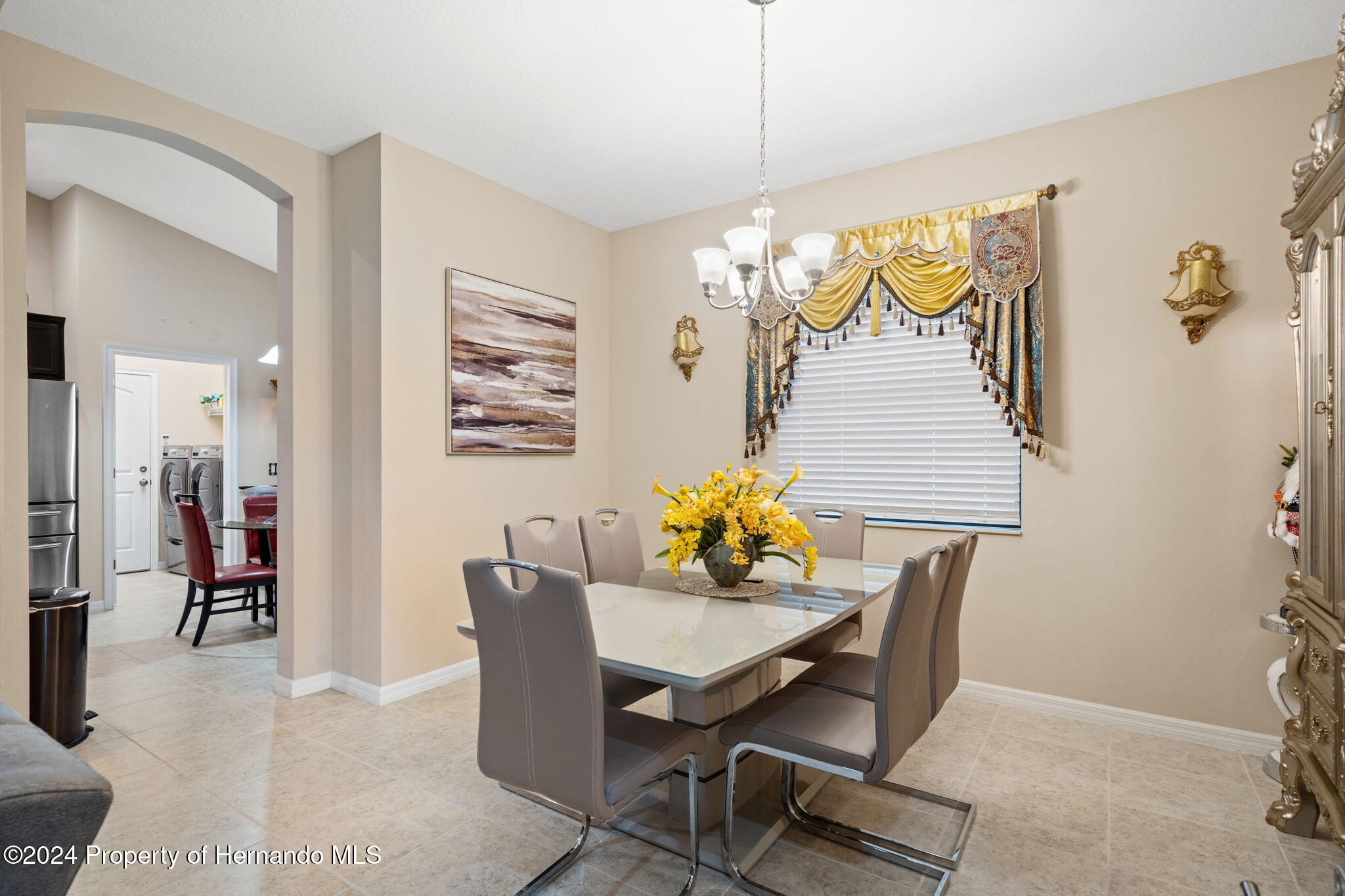 954 Old Windsor Way Spring Hill, FL 34609 - Photo 8 of 32 a view of a dining room with furniture and chandelier