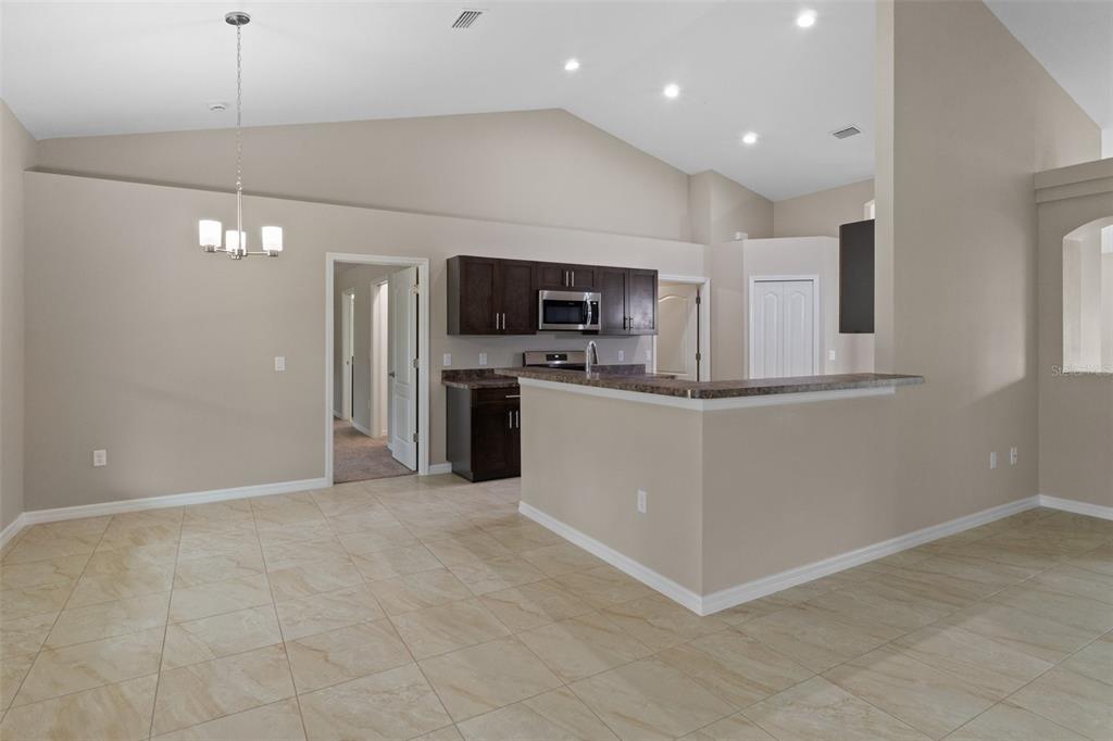 10342 Mirage Avenue Weeki Wachee, FL 34614 - Photo 12 of 45 a view of kitchen with microwave and refrigerator