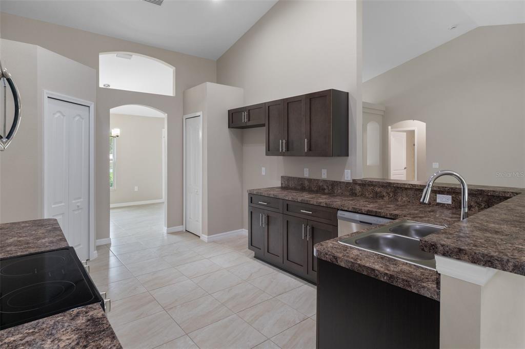 10342 Mirage Avenue Weeki Wachee, FL 34614 - Photo 17 of 45 a kitchen with granite countertop a sink and a stove top oven
