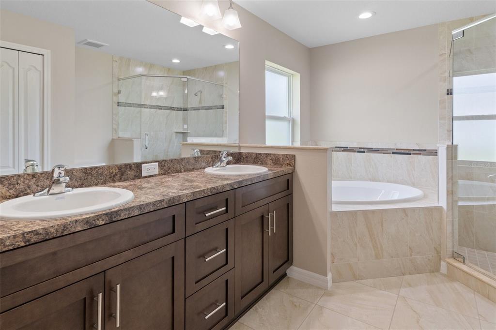 10342 Mirage Avenue Weeki Wachee, FL 34614 - Photo 28 of 45 a bathroom with a granite countertop sink and a mirror