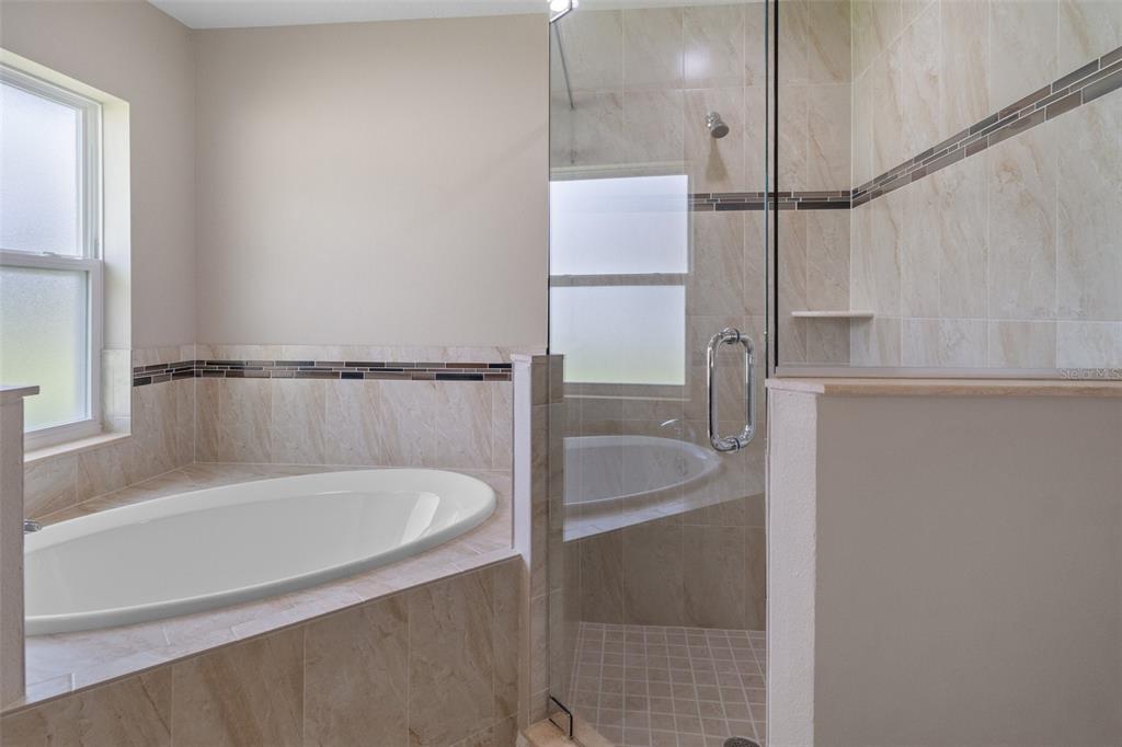 10342 Mirage Avenue Weeki Wachee, FL 34614 - Photo 29 of 45 a bathroom with a bathtub and shower