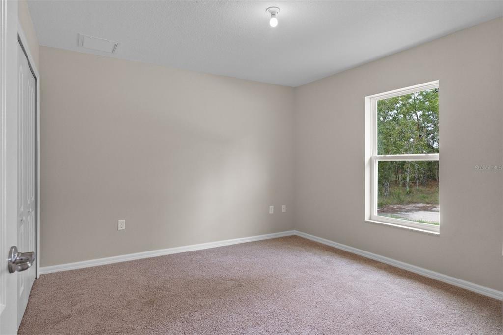 10342 Mirage Avenue Weeki Wachee, FL 34614 - Photo 34 of 45 an empty room with windows