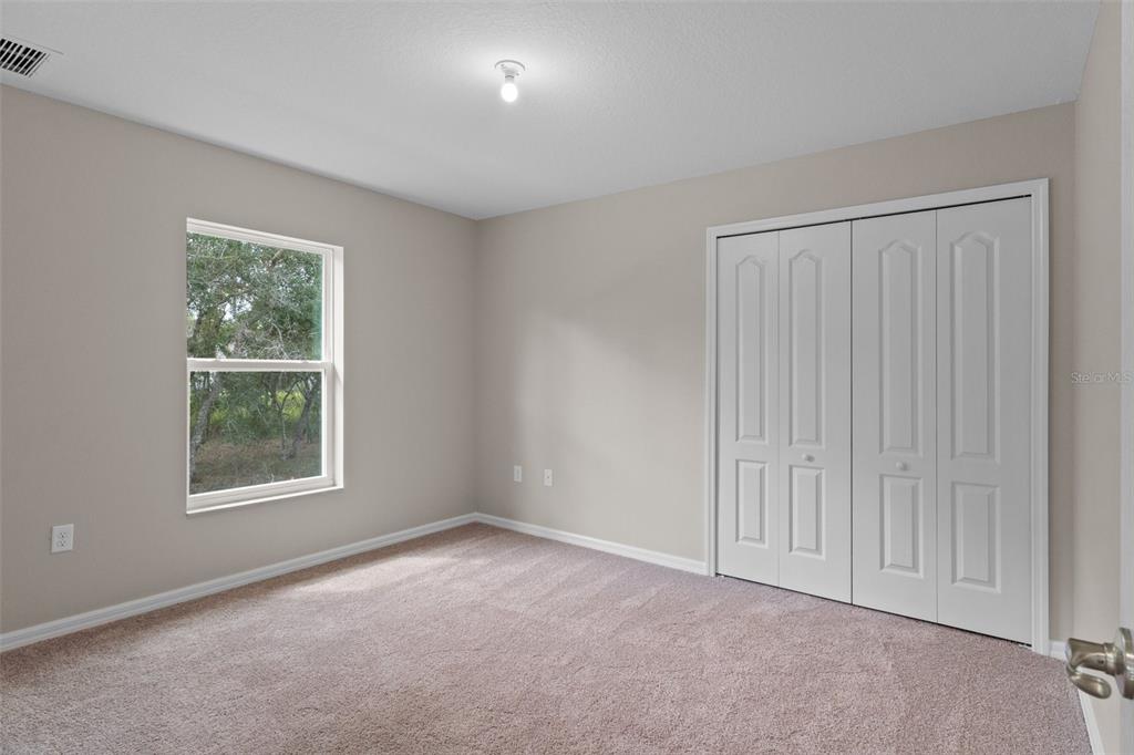 10342 Mirage Avenue Weeki Wachee, FL 34614 - Photo 37 of 45 an empty room with windows