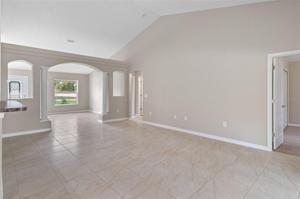 10342 Mirage Avenue Weeki Wachee, FL 34614 - Photo 10 of 45 an empty room with windows and mirror