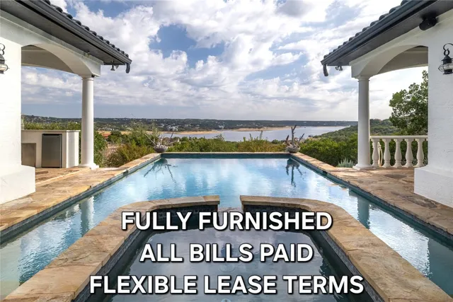 a view of swimming pool with a bench in the background