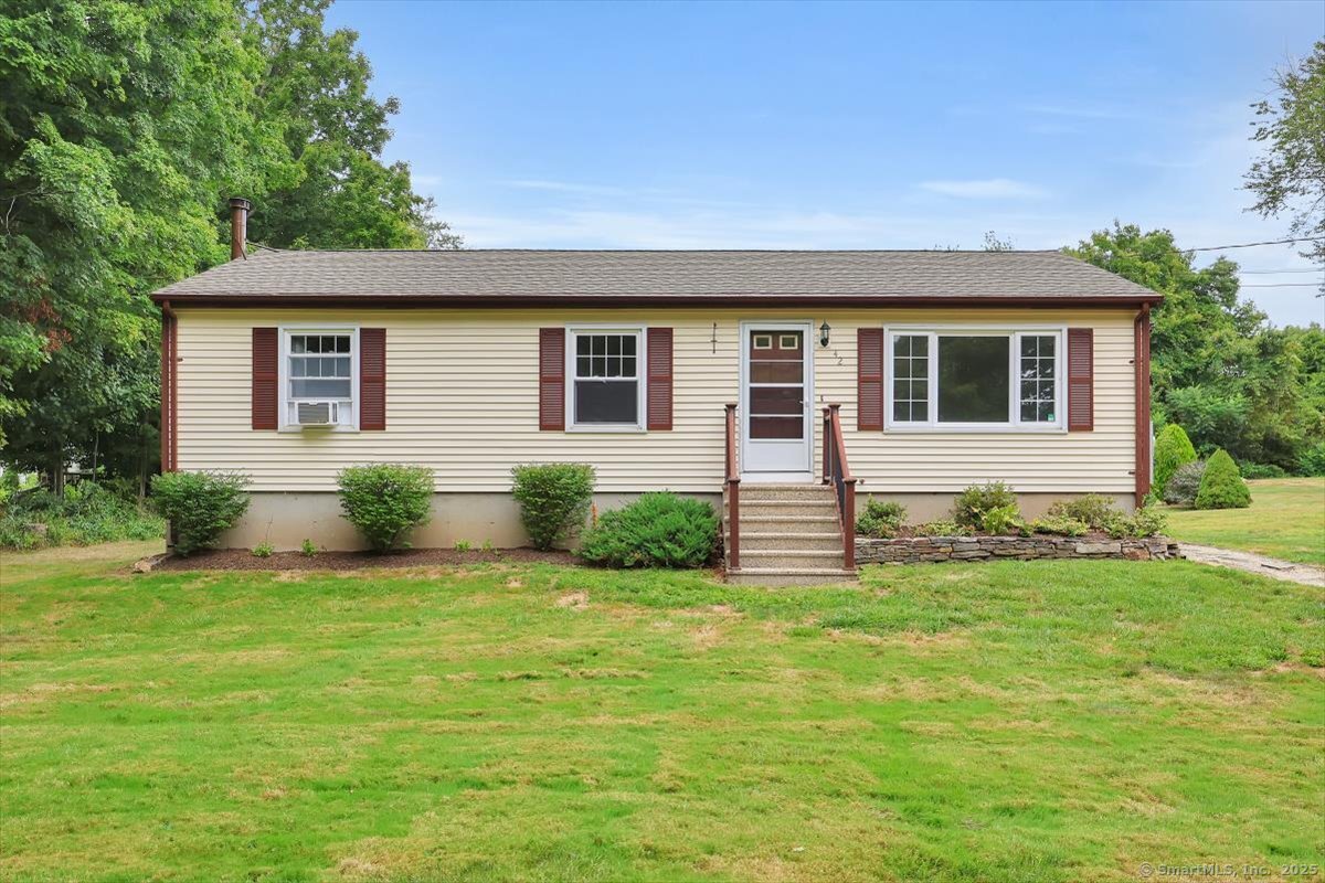 a front view of house with yard and green space