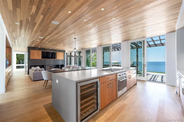 a large kitchen with stainless steel appliances granite countertop a lot of counter space and wooden floors