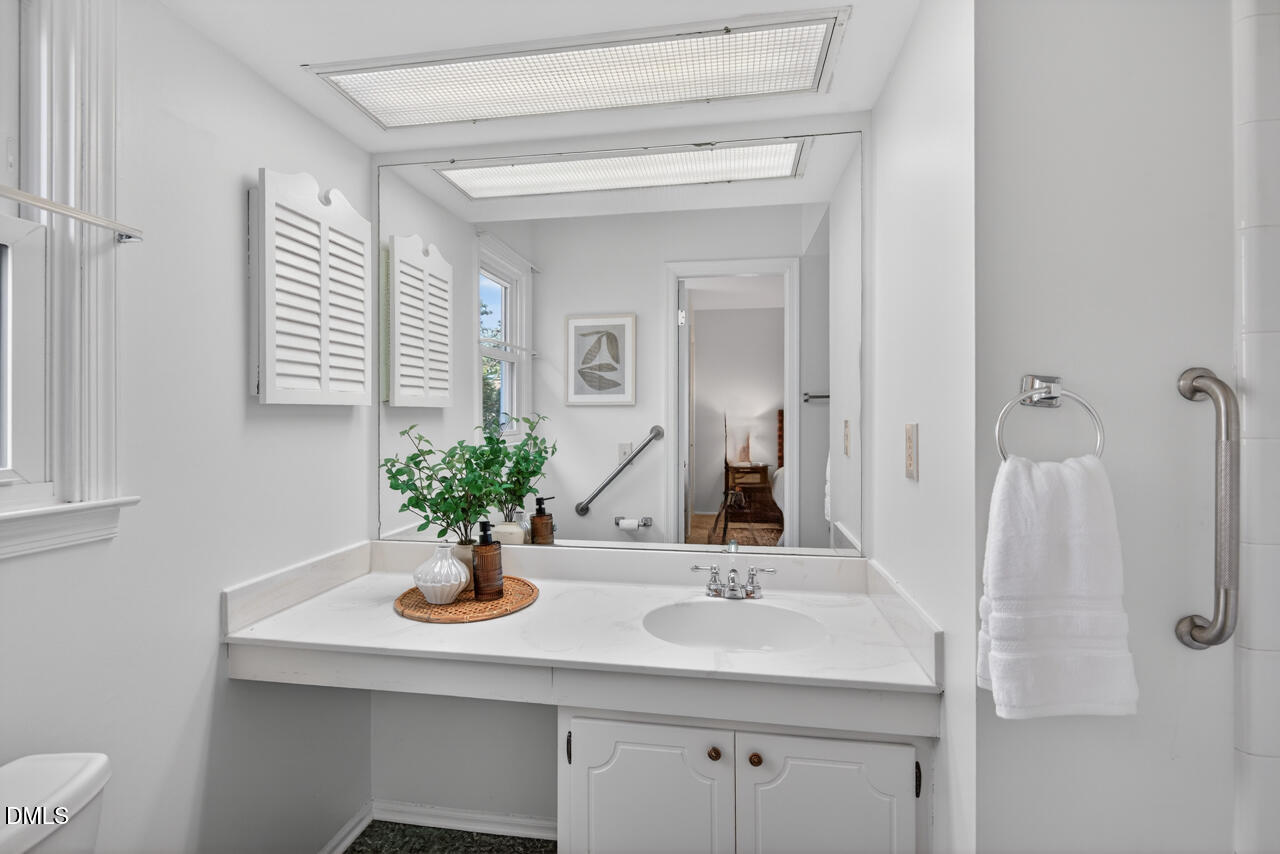 5621 Pelham Road Durham, NC 27713 - Photo 21 of 49 a bathroom with a sink and a mirror