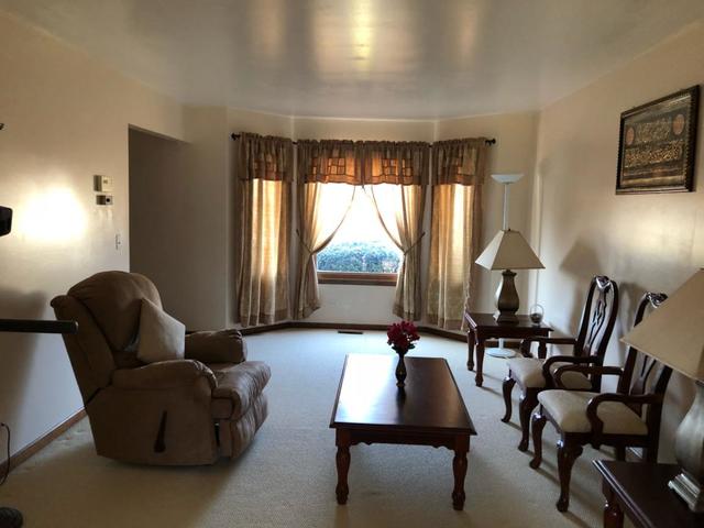 1891 President Street Glendale Heights, IL 60139 - Photo 2 of 23 a living room with furniture and a large window