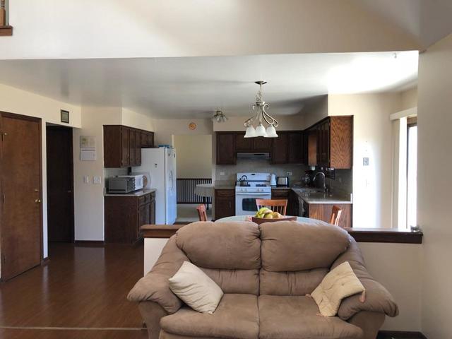 1891 President Street Glendale Heights, IL 60139 - Photo 12 of 23 a living room with stainless steel appliances kitchen island granite countertop furniture and a kitchen view