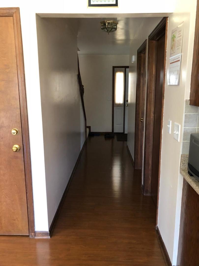 1891 President Street Glendale Heights, IL 60139 - Photo 16 of 23 a view of a hallway with wooden floor and stairs