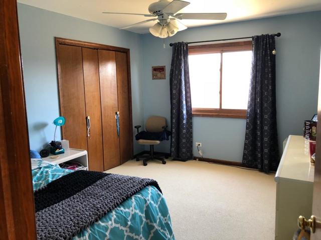 1891 President Street Glendale Heights, IL 60139 - Photo 18 of 23 a bedroom with a bed and a chandelier