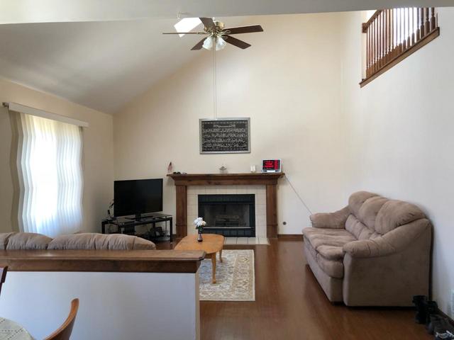 1891 President Street Glendale Heights, IL 60139 - Photo 3 of 23 a living room with furniture a fireplace and a flat screen tv