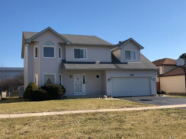 1891 President Street Glendale Heights, IL 60139 - Photo 23 of 23 a front view of a house with a garden
