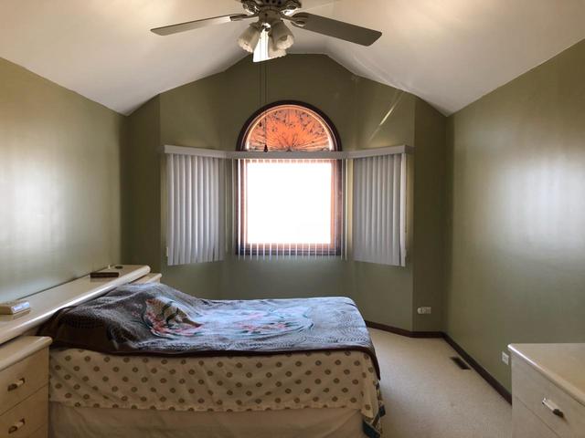 1891 President Street Glendale Heights, IL 60139 - Photo 6 of 23 a bedroom with a bed and a chandelier