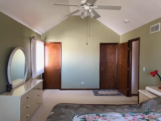 1891 President Street Glendale Heights, IL 60139 - Photo 8 of 23 a bedroom with a bed and a mirror