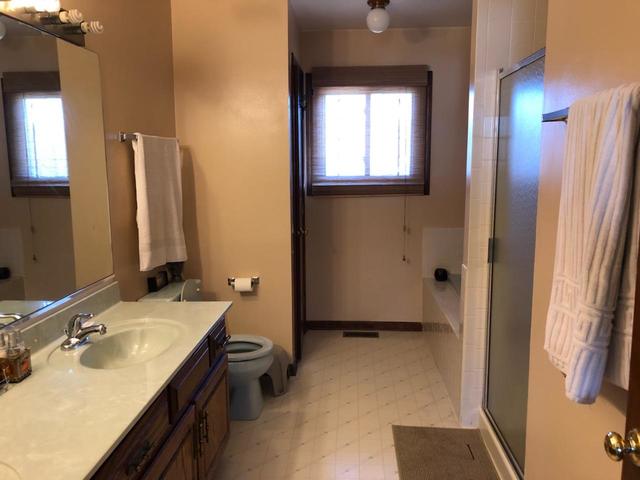 1891 President Street Glendale Heights, IL 60139 - Photo 9 of 23 a bathroom with a double vanity sink and mirror with toilet