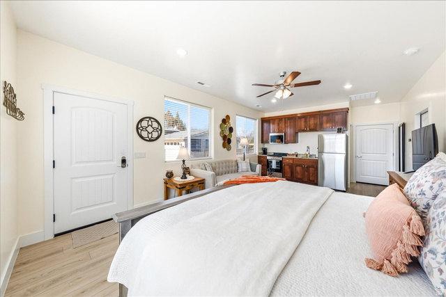 357 East Main Street Enterprise, UT 84725 - Photo 49 of 71 Bedroom featuring light wood-type flooring, freestanding refrigerator, ceiling fan, and recessed lighting