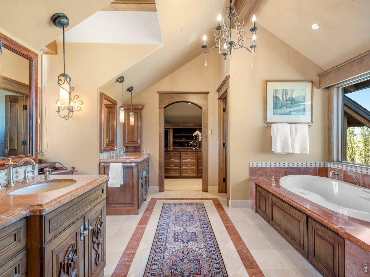 15383 East County Line Road Berthoud, CO 80513 - Photo 29 of 47 a spacious bathroom with a tub double sink and a mirror