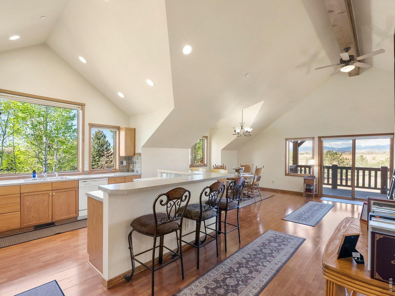 15383 East County Line Road Berthoud, CO 80513 - Photo 41 of 47 a view of a dining room with furniture window and wooden floor