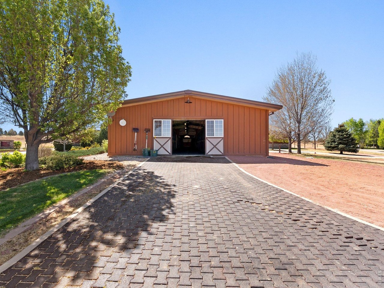 15383 East County Line Road Berthoud, CO 80513 - Photo 9 of 47 a front view of a house with a yard