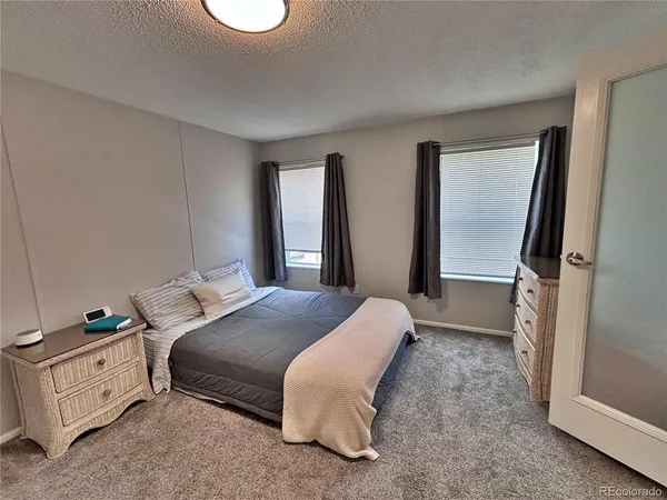 a living room with a couch and a walk in closet