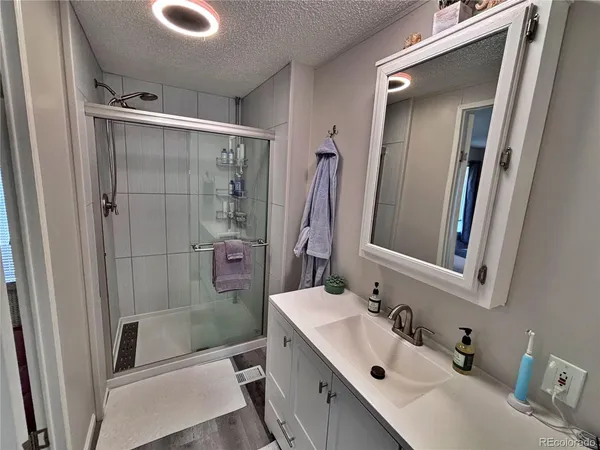 a bathroom with a double vanity sink toilet and shower