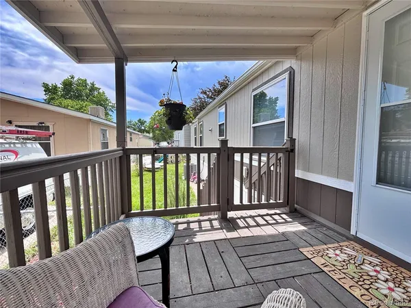 a view of a hallway and wooden floor with an outdoor space