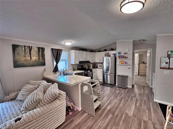a kitchen that has a sink and a stove in it