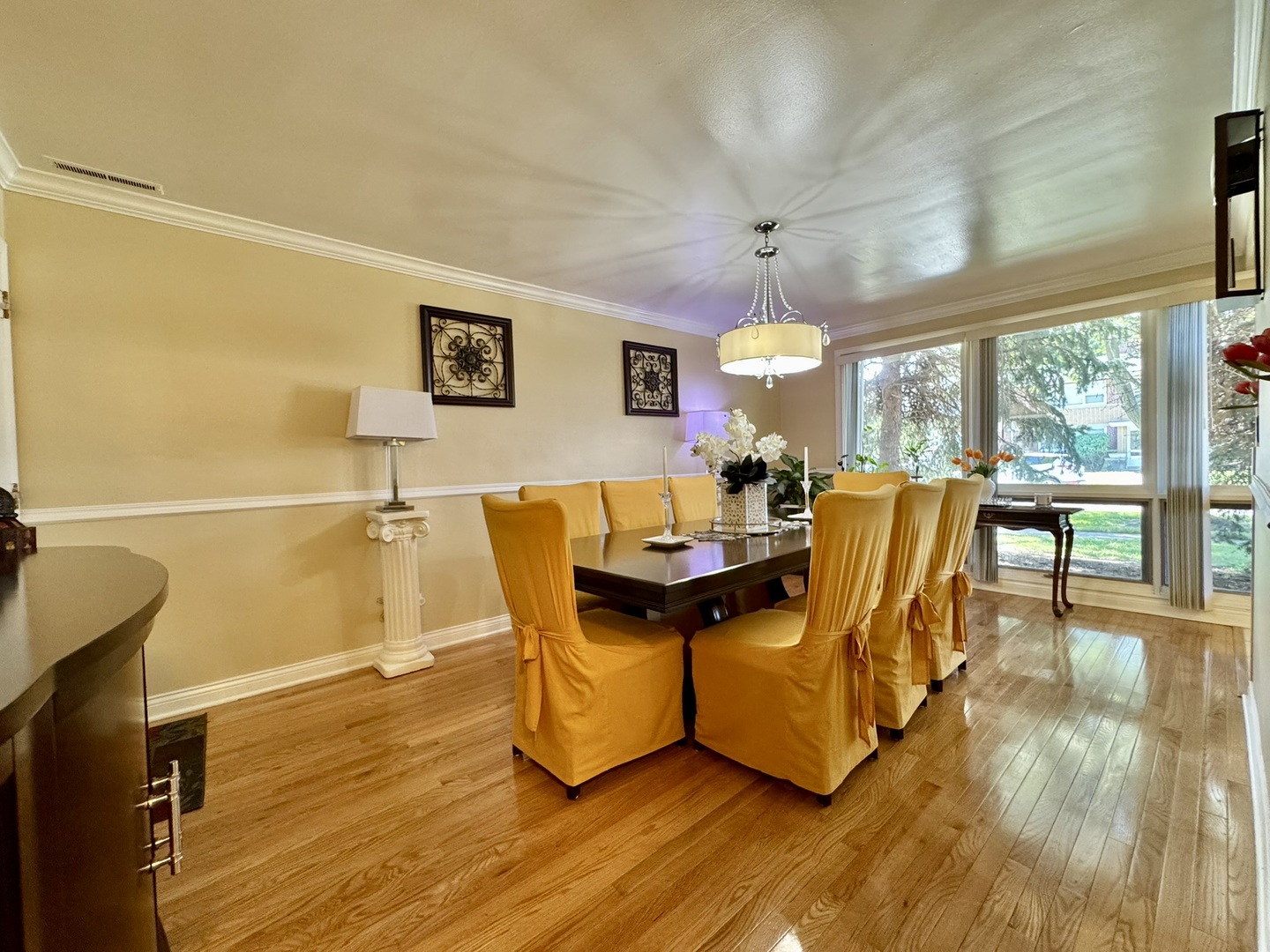 1247 South Mannheim Road, Unit 3 Westchester, IL 60154 - Photo 17 of 41 a view of a dining room with furniture a chandelier and wooden floor