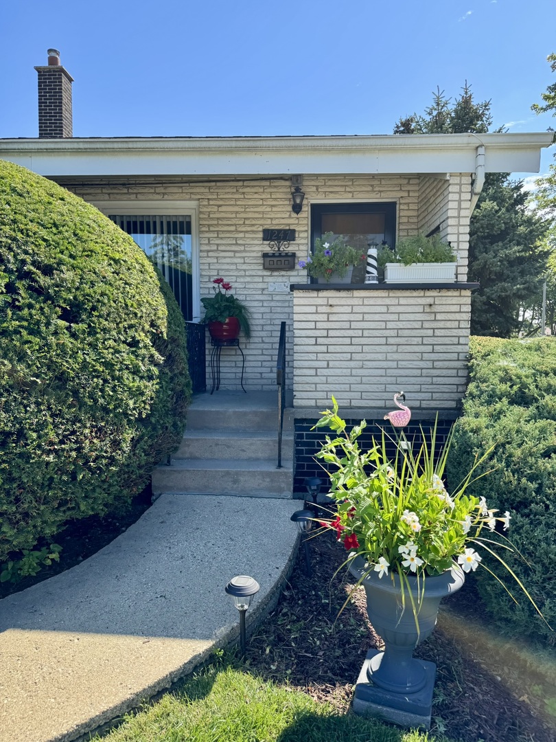 1247 South Mannheim Road, Unit 3 Westchester, IL 60154 - Photo 2 of 41 a front view of a house with a yard