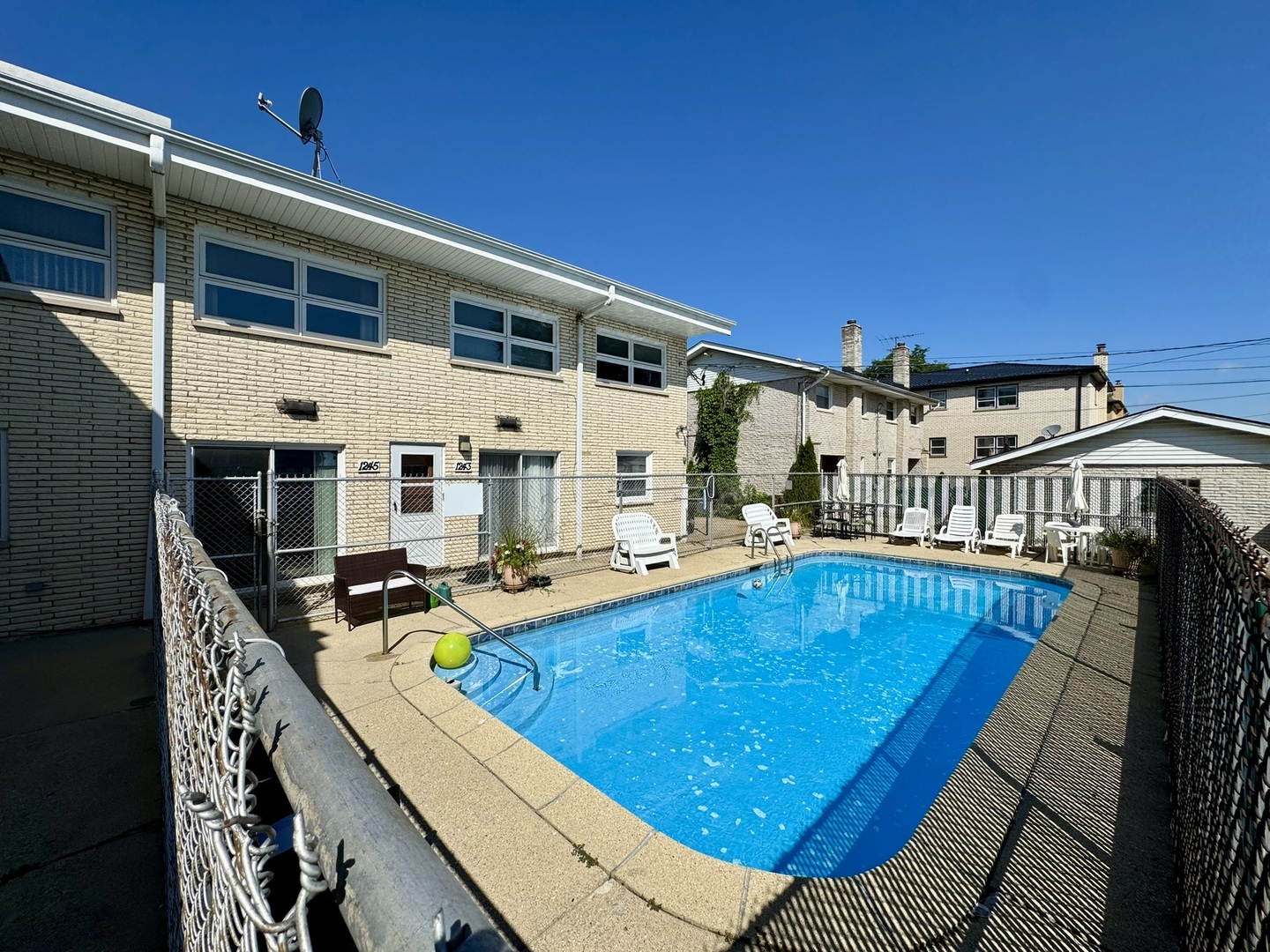 1247 South Mannheim Road, Unit 3 Westchester, IL 60154 - Photo 39 of 41 a view of a house with pool and chairs