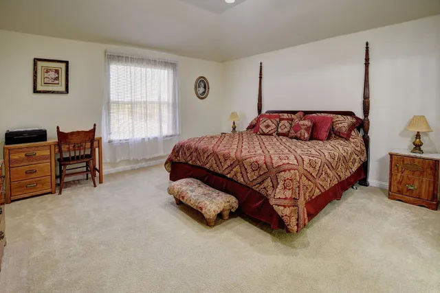 a bedroom with a bed and a dresser