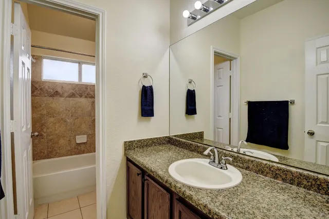 a bed sitting in a bedroom and flat screen tv