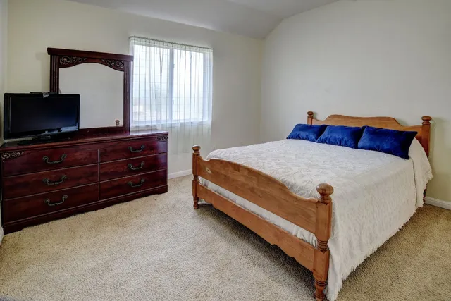 a bedroom with a bed and a window