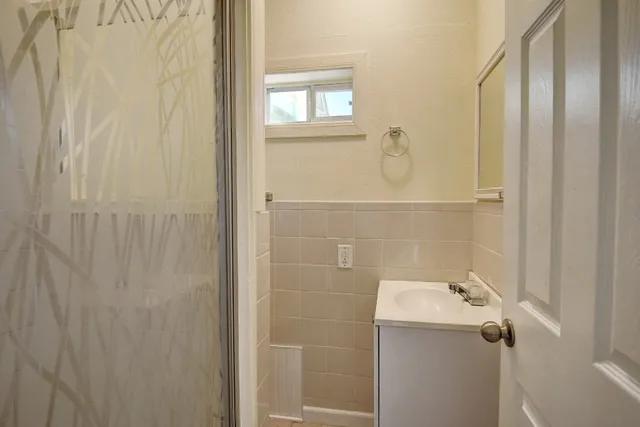 a dining room with furniture and a refrigerator