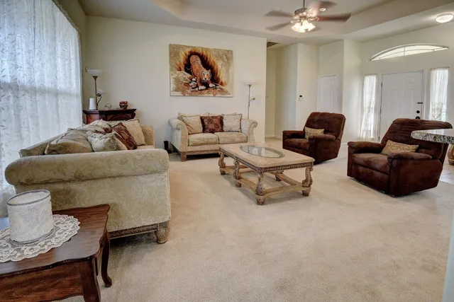 a living room with furniture and a chandelier