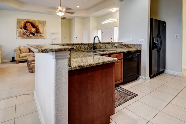 a kitchen with stainless steel appliances granite countertop a sink stove and cabinets
