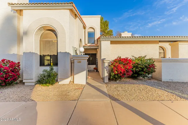 a front view of a house with a garden