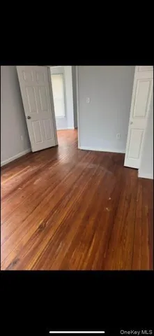 a view of hallway with wooden floor