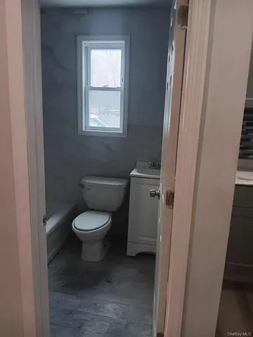 a bathroom with a bathtub window and shower