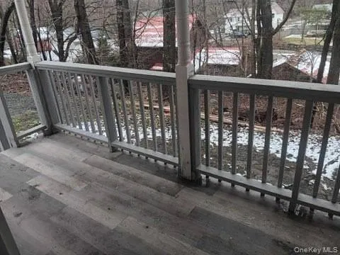 a view of a wooden deck with a backyard