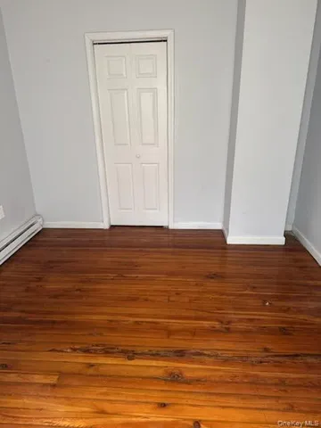 a view of room with wooden floor