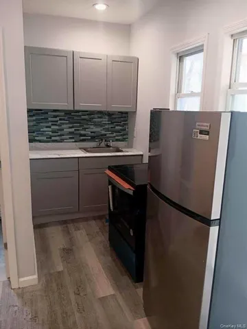 a kitchen with stainless steel appliances granite countertop a refrigerator and a sink