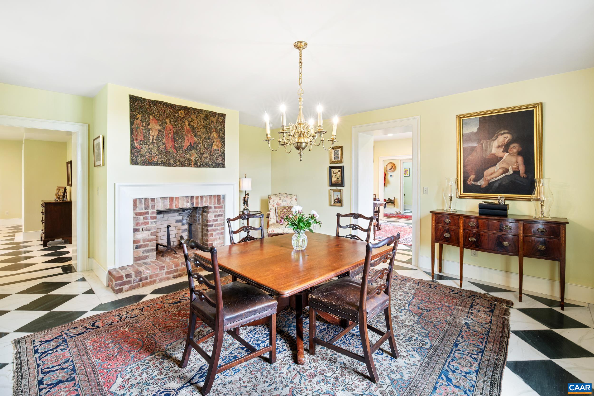3276 Buckingham Springs Road Dillwyn, VA 23936 - Photo 12 of 47 a dining room with furniture a rug and a chandelier
