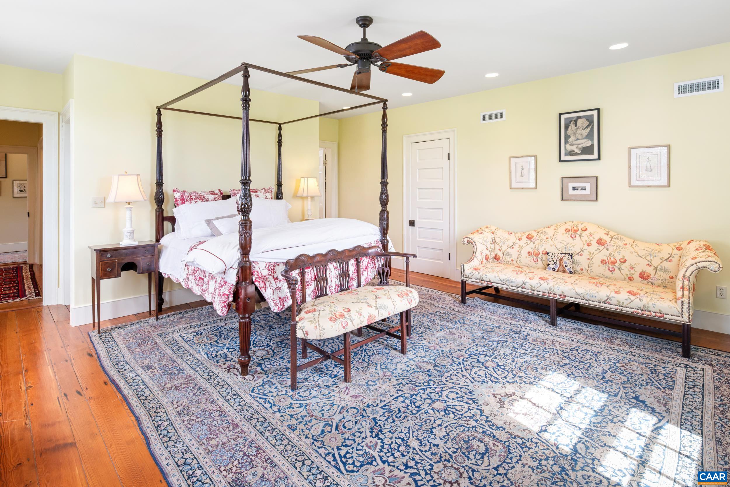 3276 Buckingham Springs Road Dillwyn, VA 23936 - Photo 24 of 47 a bedroom with a bed a lamp and a rug