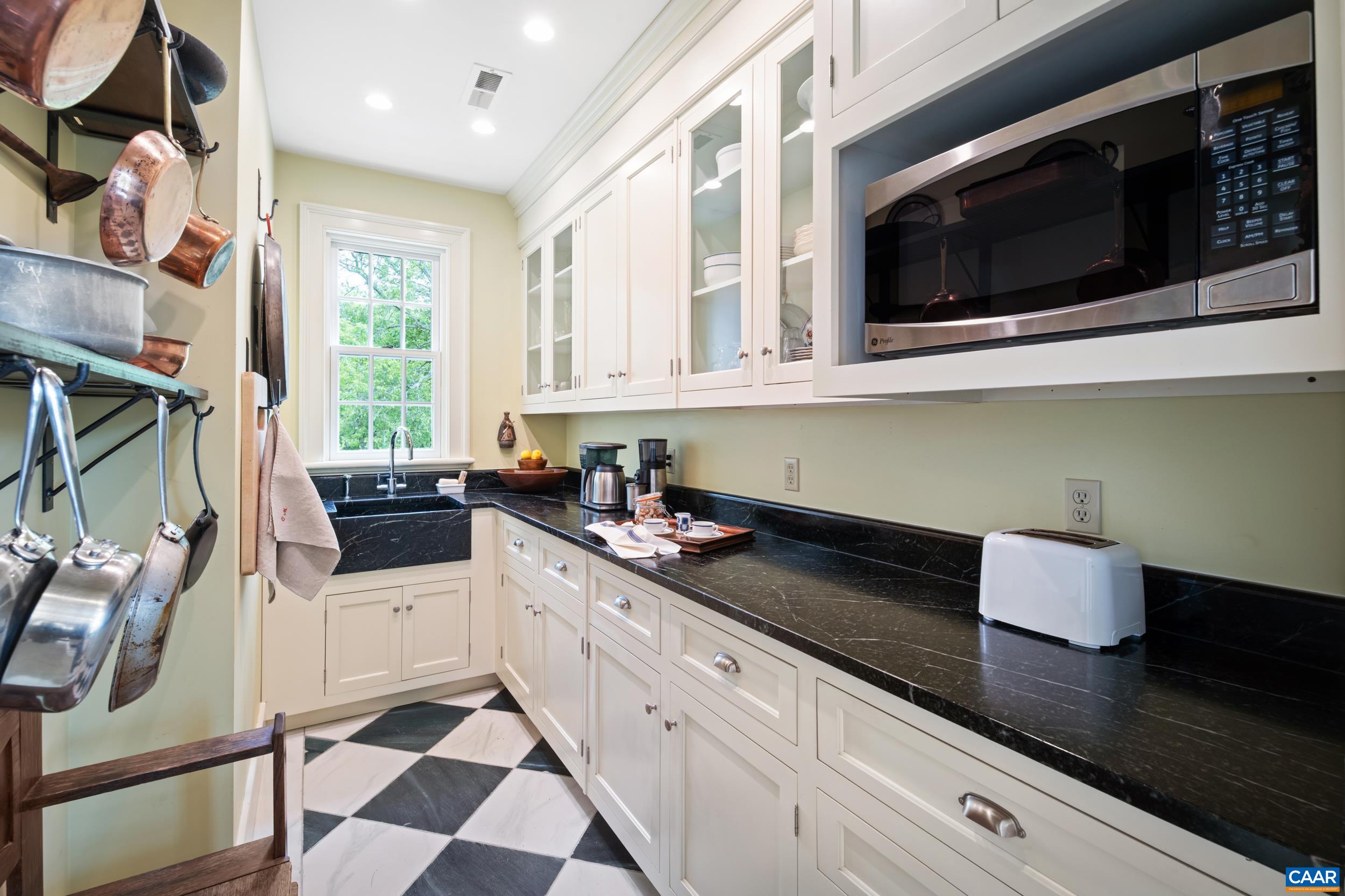 3276 Buckingham Springs Road Dillwyn, VA 23936 - Photo 9 of 47 a kitchen with stainless steel appliances kitchen island granite countertop a sink and a microwave