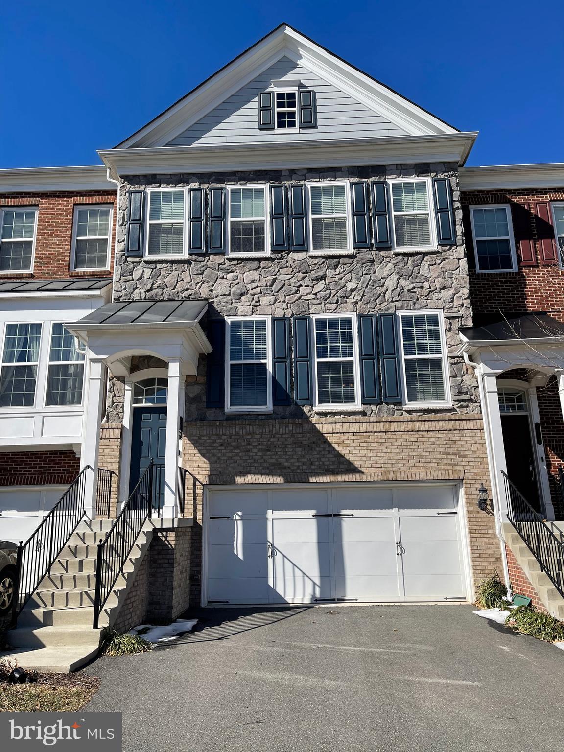 20727 Erskine Terrace Ashburn, VA 20147 - Photo 1 of 38 a front view of a house with a parking space