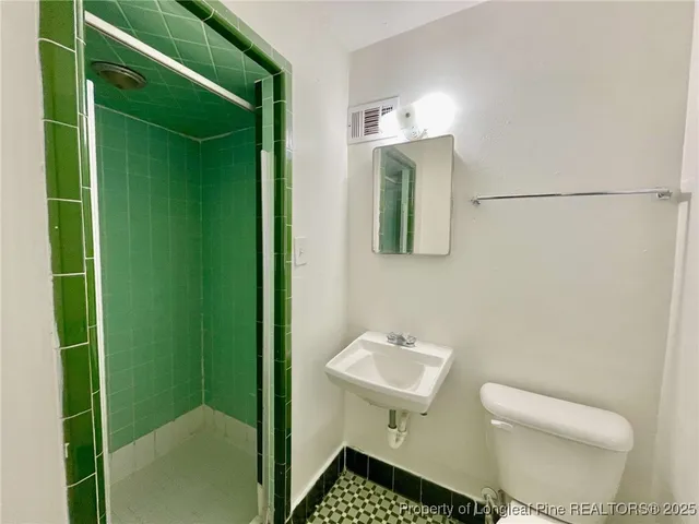 a bathroom with a sink toilet and mirror